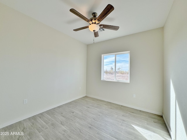 empty room featuring light wood finished floors, visible vents, ceiling fan, and baseboards