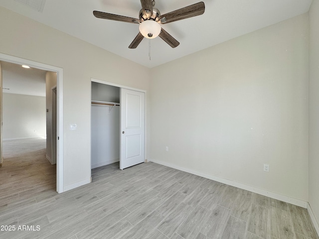 unfurnished bedroom featuring light wood finished floors, visible vents, baseboards, and a closet