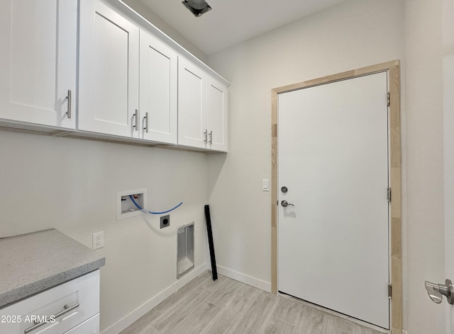 clothes washing area with cabinet space, light wood finished floors, baseboards, hookup for an electric dryer, and hookup for a washing machine