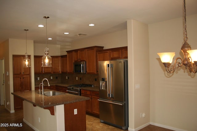 15387 W Columbine Dr, Surprise, AZ 85379 - kitchen with a sink, premium appliances, decorative backsplash, brown cabinets, and a breakfast bar area