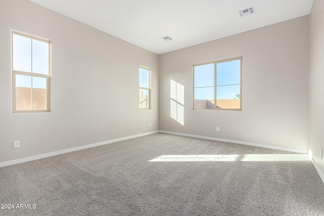 spare room featuring light colored carpet