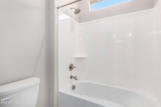 bathroom with toilet and bathtub / shower combination