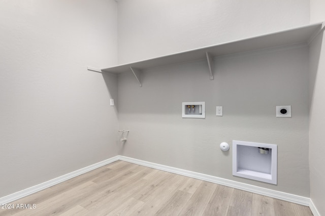 clothes washing area with light hardwood / wood-style flooring, hookup for a washing machine, gas dryer hookup, and electric dryer hookup