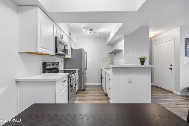10610 S 48th St Unit 1096, Phoenix, AZ 85044 - kitchen with appliances with stainless steel finishes, light wood-style floors, white cabinetry, and light countertops