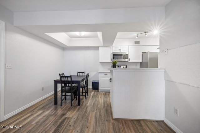 10610 S 48th St Unit 1096, Phoenix, AZ 85044 - dining space with dark wood-style flooring and a raised ceiling