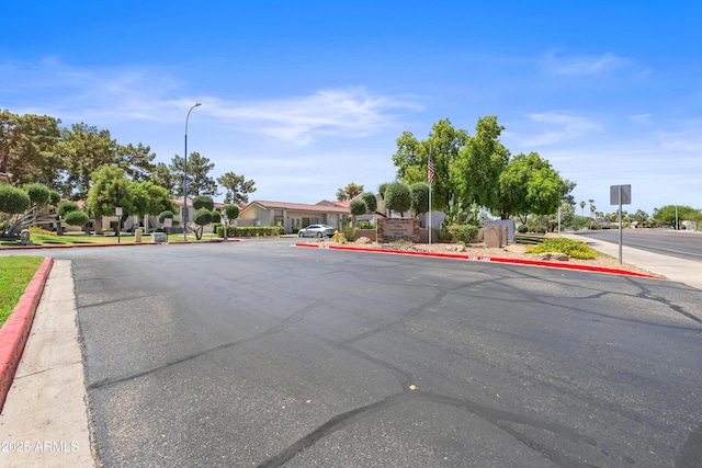 10610 S 48th St Unit 1096, Phoenix, AZ 85044 - view of asphalt road featuring curbs, street lighting, sidewalks, traffic signs, and a residential view
