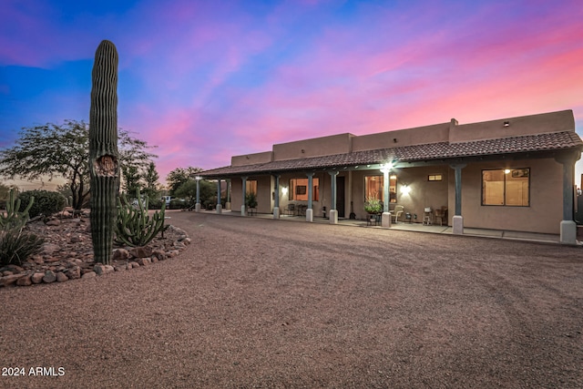 view of back house at dusk