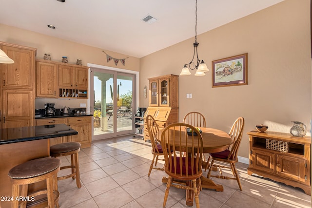 dining room with light tile patterned flooring and a chandelier