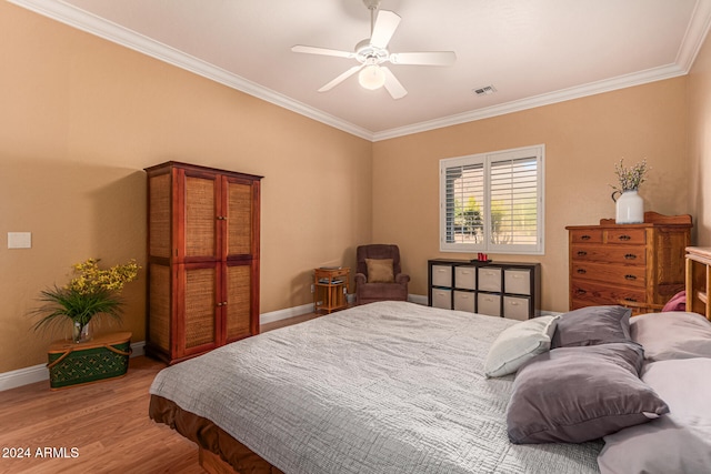 bedroom with ceiling fan, crown molding, and wood-type flooring