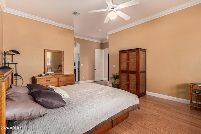 bedroom with light wood-type flooring, ceiling fan, and ornamental molding