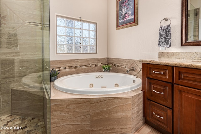 bathroom with vanity and separate shower and tub