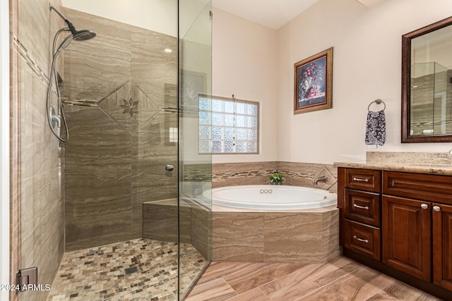 bathroom with separate shower and tub and vanity