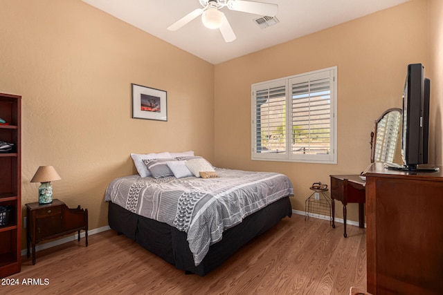 bedroom with ceiling fan and light hardwood / wood-style floors