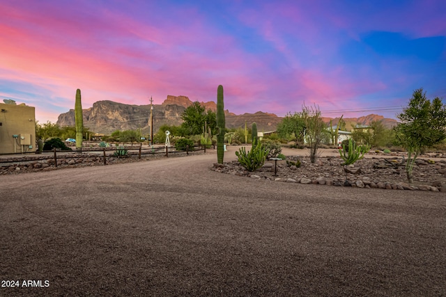 yard at dusk featuring a mountain view