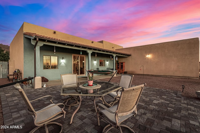 view of patio terrace at dusk