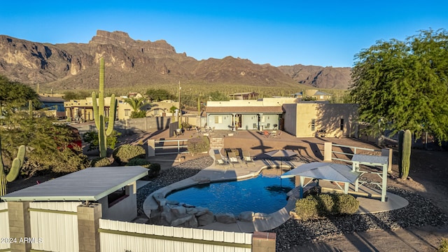 view of swimming pool featuring a patio area and a mountain view