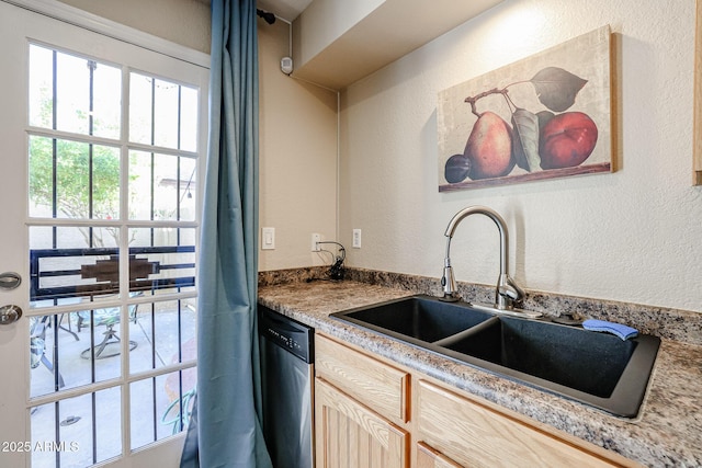 kitchen featuring dishwasher, light brown cabinets, and sink