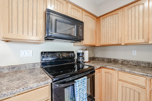 kitchen featuring light brown cabinets and black appliances