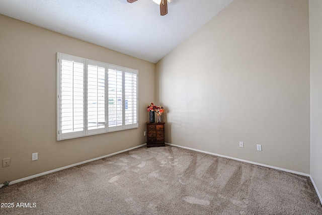 carpeted empty room featuring vaulted ceiling and ceiling fan