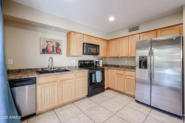 kitchen featuring sink, light tile patterned flooring, black appliances, and light brown cabinets