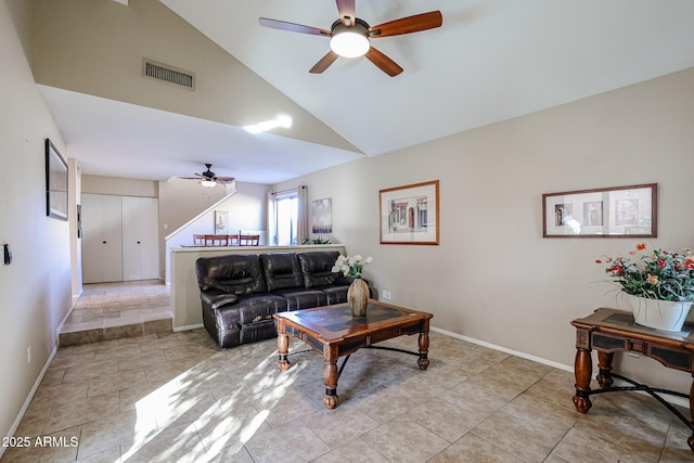 tiled living room featuring ceiling fan and high vaulted ceiling