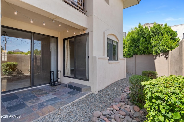 3235 E Camelback Rd Unit 124, Phoenix, AZ 85018 - view of exterior entry with stucco siding and a patio