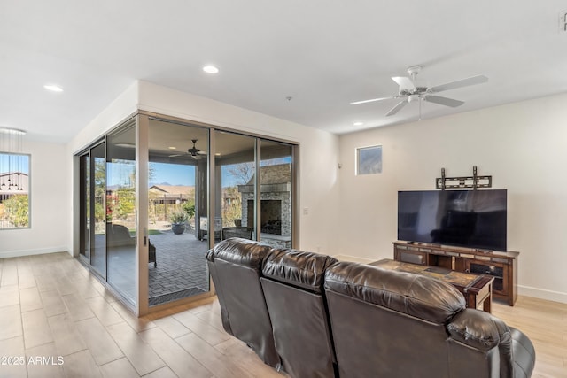 living room with light hardwood / wood-style flooring and ceiling fan