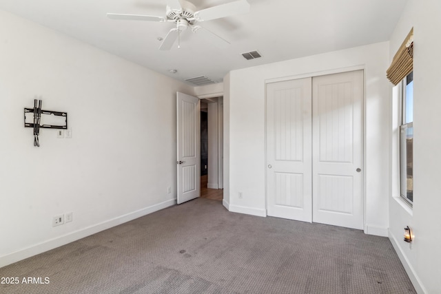 unfurnished bedroom with a closet, ceiling fan, and carpet flooring