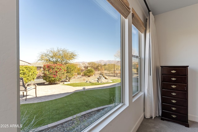 interior space featuring a mountain view and carpet flooring