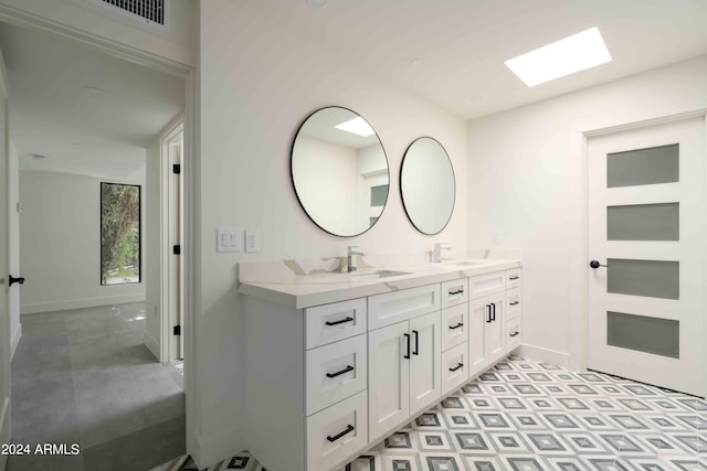 bathroom with a skylight and vanity