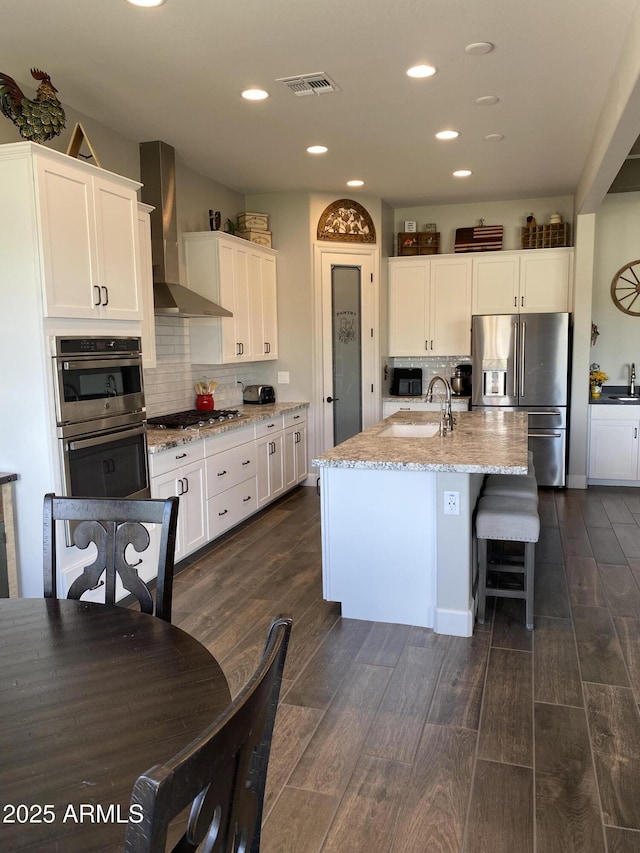 4114 Copperhead Dr, Wickenburg, AZ 85390 - kitchen with appliances with stainless steel finishes, wall chimney exhaust hood, a sink, decorative backsplash, and recessed lighting
