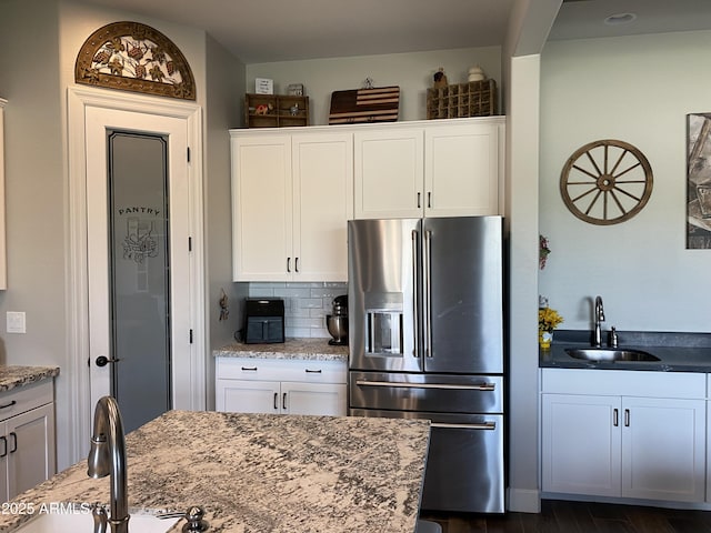 4114 Copperhead Dr, Wickenburg, AZ 85390 - kitchen featuring stainless steel fridge with ice dispenser, a sink, white cabinets, and decorative backsplash
