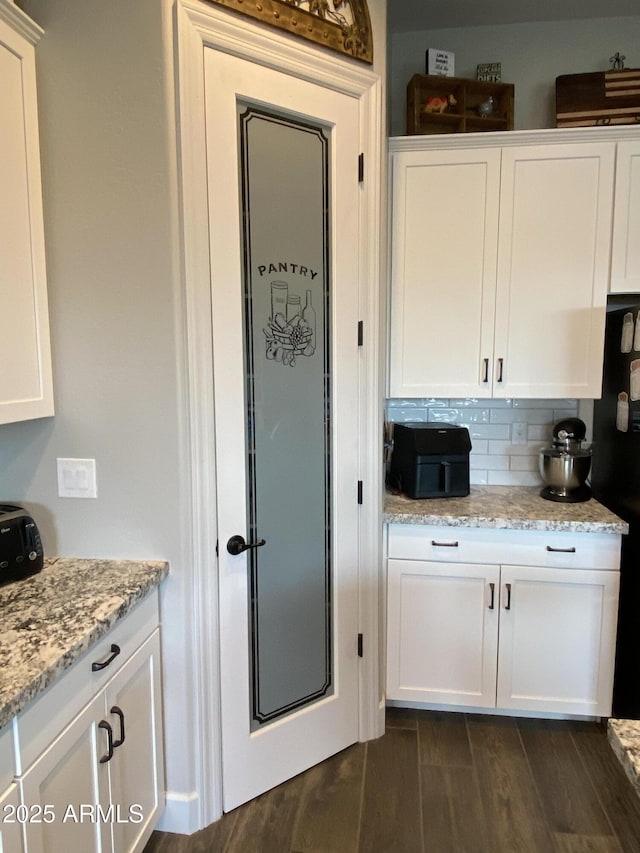4114 Copperhead Dr, Wickenburg, AZ 85390 - kitchen featuring freestanding refrigerator, white cabinets, dark wood finished floors, and light stone countertops