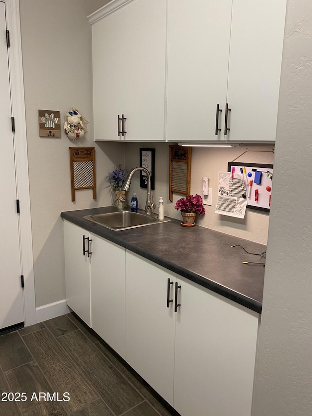4114 Copperhead Dr, Wickenburg, AZ 85390 - kitchen featuring a sink, dark countertops, white cabinetry, and baseboards