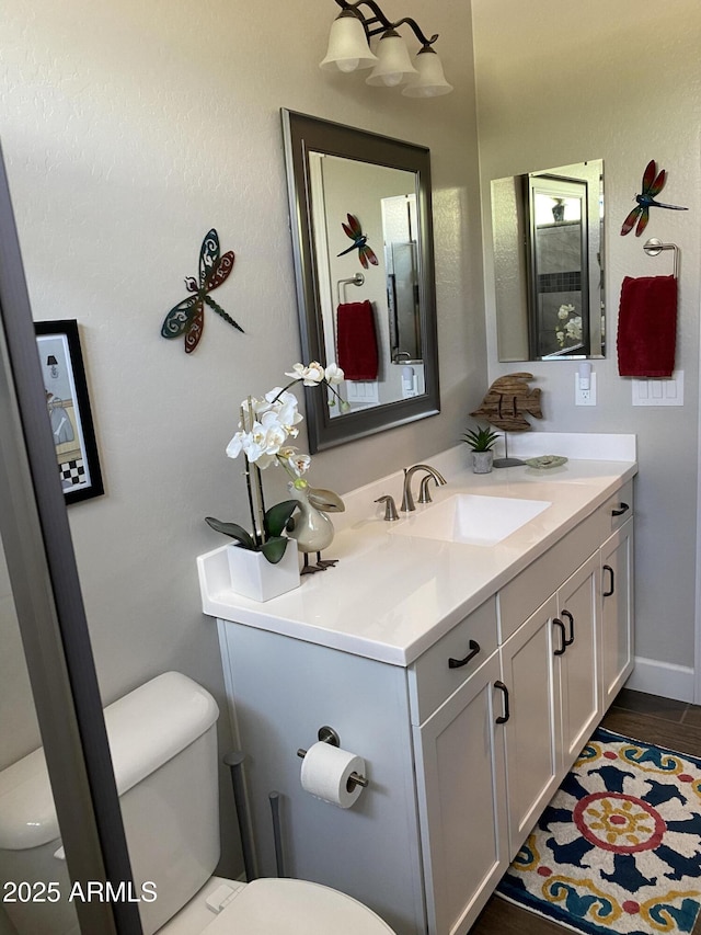 4114 Copperhead Dr, Wickenburg, AZ 85390 - bathroom featuring toilet, vanity, and wood finished floors
