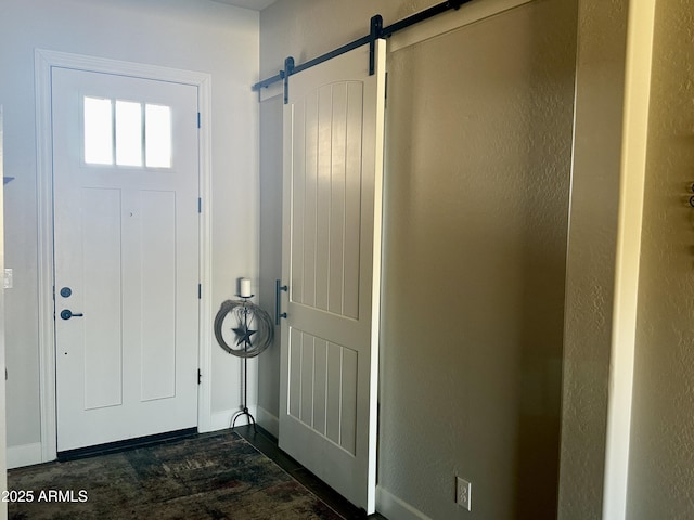 4114 Copperhead Dr, Wickenburg, AZ 85390 - entrance foyer featuring baseboards, a barn door, dark wood-type flooring, and a textured wall