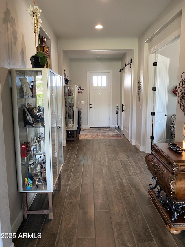 4114 Copperhead Dr, Wickenburg, AZ 85390 - entryway featuring dark wood-style floors, a barn door, baseboards, and recessed lighting