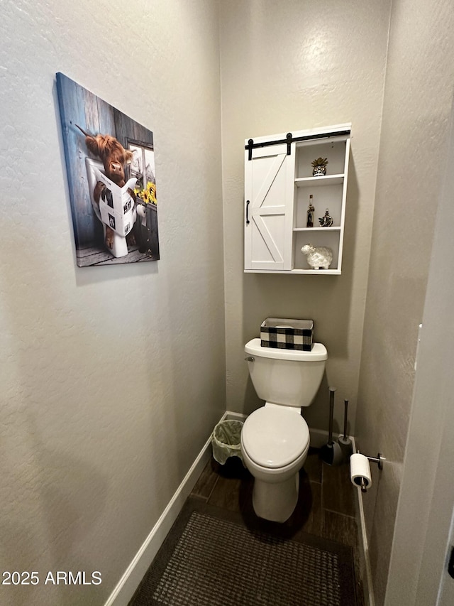 4114 Copperhead Dr, Wickenburg, AZ 85390 - bathroom featuring baseboards, toilet, and a textured wall