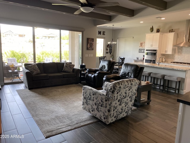 4114 Copperhead Dr, Wickenburg, AZ 85390 - living area with beamed ceiling, ceiling fan, dark wood-style floors, recessed lighting, and a chandelier
