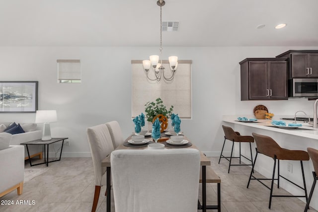 tiled dining area with a notable chandelier