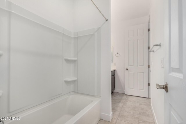 bathroom with tile patterned flooring, vanity, and washtub / shower combination