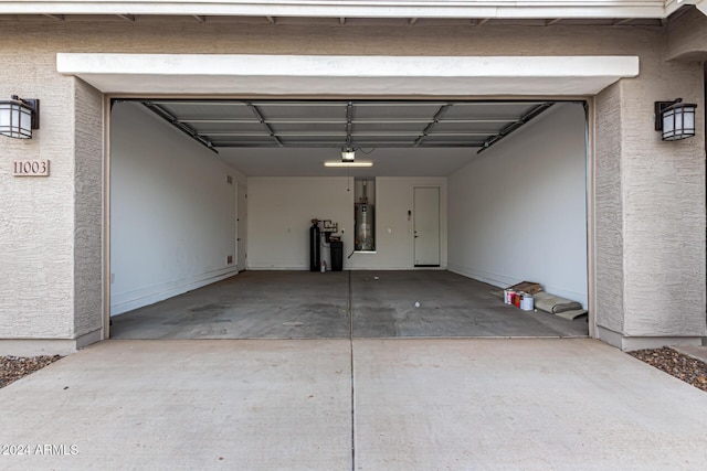 garage featuring gas water heater and a garage door opener