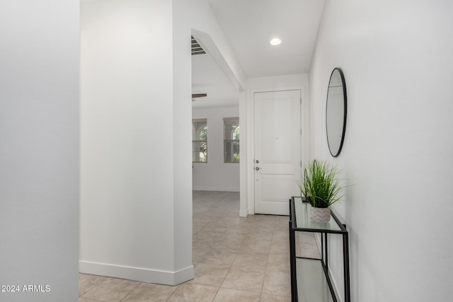 hall with light tile patterned floors