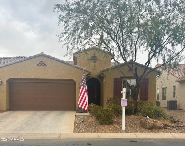 ranch-style home with cooling unit and a garage