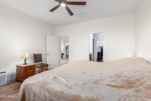 bedroom featuring ensuite bath, ceiling fan, and light hardwood / wood-style floors