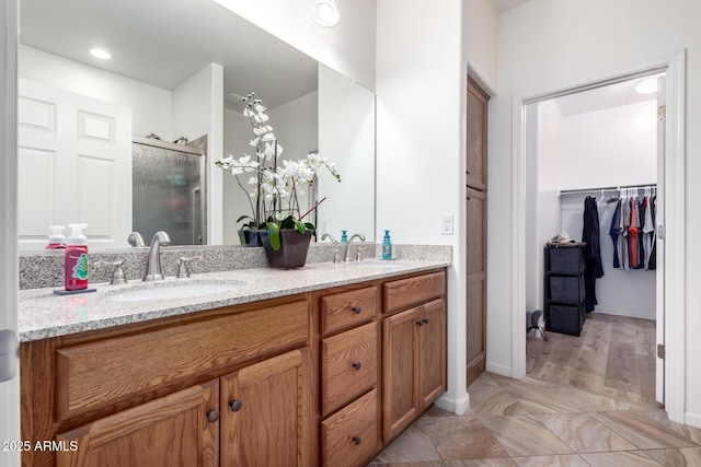 bathroom featuring vanity and an enclosed shower