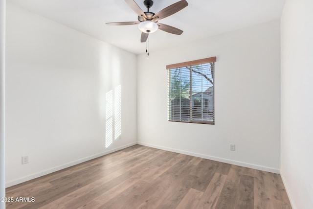 spare room with hardwood / wood-style floors and ceiling fan