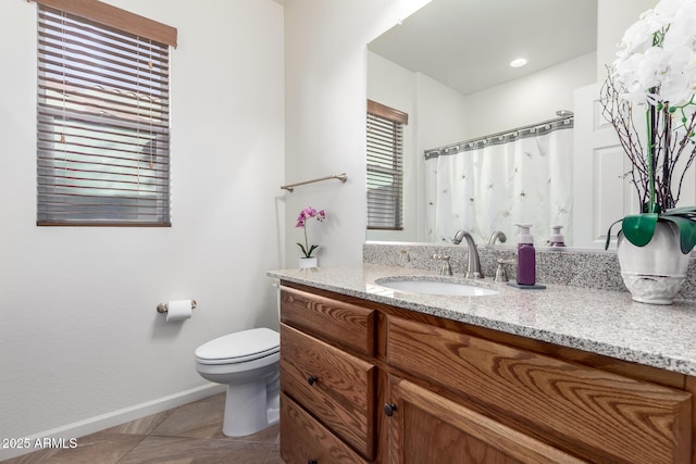 bathroom featuring tile patterned floors, vanity, and toilet