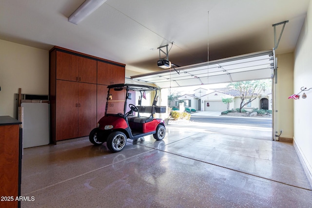 garage featuring white fridge and a garage door opener