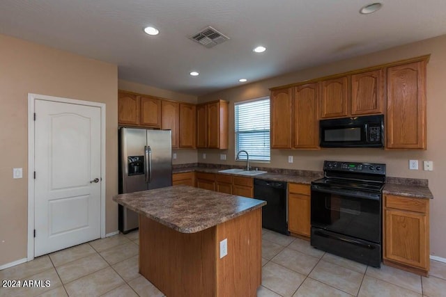 kitchen with light tile patterned flooring, a center island, sink, and black appliances